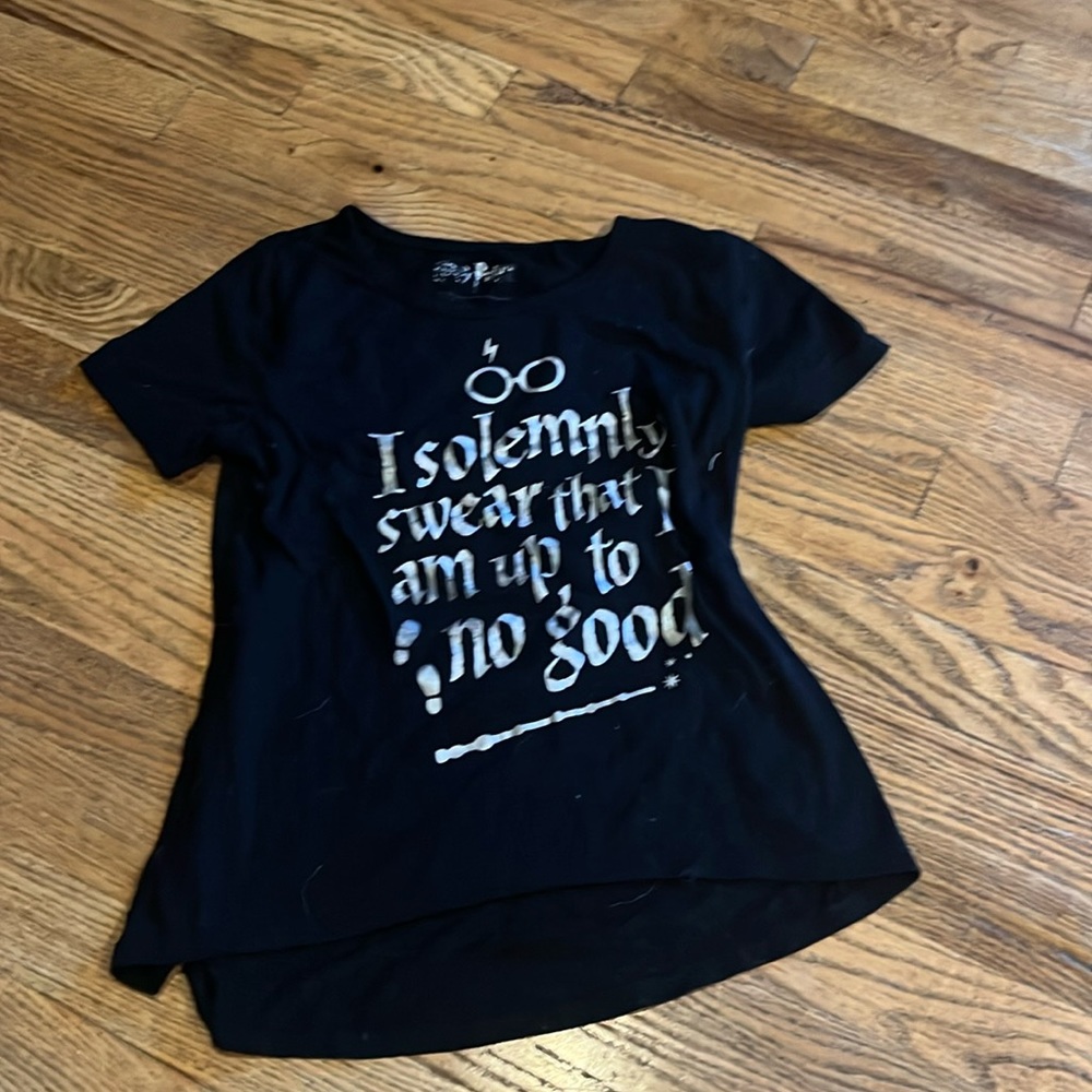 I'm selling a black and silver Harry Potter shirt it's a size M 10/12